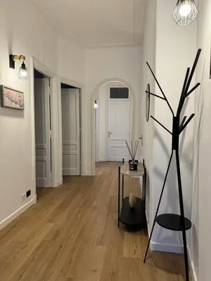 a living room with a table and a hallway at Casa Palmiero in Rome