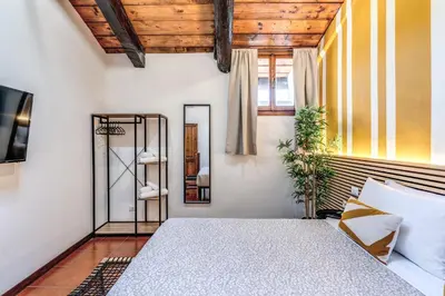 a bedroom with a bed and a mirror at Elena Vatican Apartment in Rome