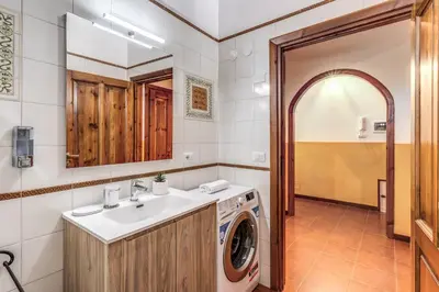 a bathroom with a washing machine and a sink at Elena Vatican Apartment in Rome
