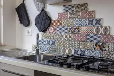 a kitchen with a sink and a tile wall at Radio Guest House Intero Appartamento Moderno A Trastevere in Rome