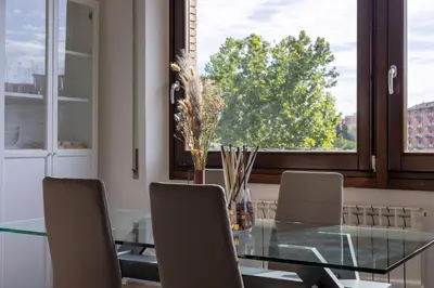 a dining room with a glass table and chairs and a window at Radio Guest House Intero Appartamento Moderno A Trastevere in Rome