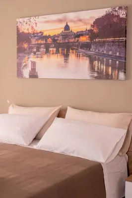 a bedroom with a bed with a painting on the wall at Antonella in Rome