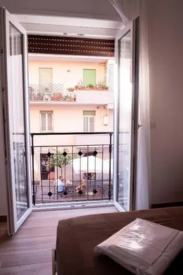 a bedroom with a large window with a view of a building at Antonella in Rome