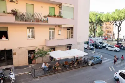 a group of people sitting at a table outside of a building at Antonella in Rome
