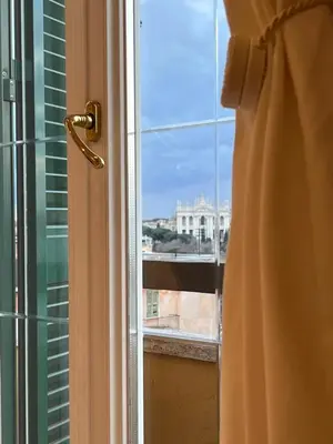 a window with a view of a building at Casa Roma San Giovanni in Rome