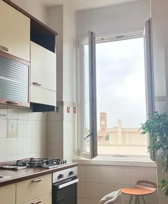 a kitchen with a window and a stove top oven at Casa Roma San Giovanni in Rome
