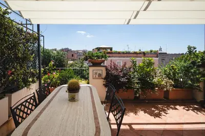 a table on a balcony with a cactus on it at Valeria Terrace - Monti, Rome in Rome