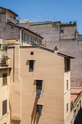 a large brown building with windows in a city at Valeria Terrace - Monti, Rome in Rome