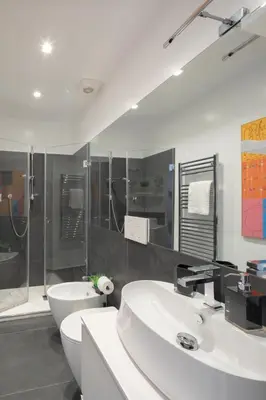 a bathroom with two sinks and a shower and a toilet at Valeria Terrace - Monti, Rome in Rome
