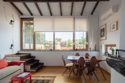 a living room with a table and a couch at Valeria Terrace - Monti, Rome in Rome