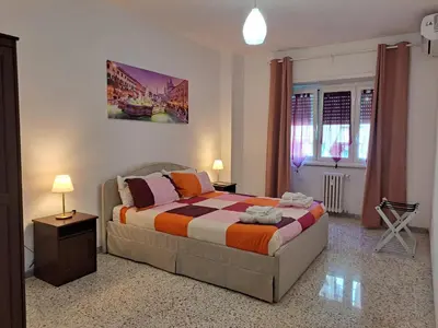 a bedroom with a king sized bed in a room at Roman Holidays Apartment in Rome