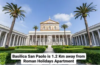 a building with palm trees in front of it at Roman Holidays Apartment in Rome