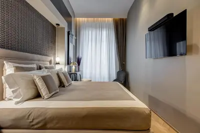 a bedroom with a large bed with a television on the wall at BDC - Luxurylifestyle in Rome