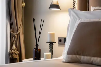a candle on a table next to a bed at BDC - Luxurylifestyle in Rome