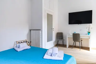 a bedroom with a blue bed with towels on it at MH Luxury Suite Pantheon in Rome