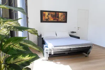 a bed in a room with a plant at MH Luxury Suite Pantheon in Rome