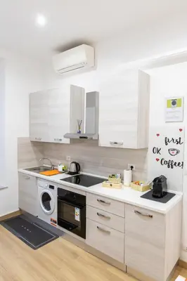 a white kitchen with a sink and a dishwasher at MH Luxury Suite Pantheon in Rome