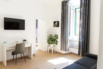 a living room with a blue couch and a desk at MH Luxury Suite Pantheon in Rome