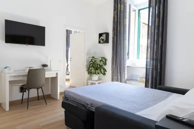 a bedroom with a bed and a desk and a window at MH Luxury Suite Pantheon in Rome