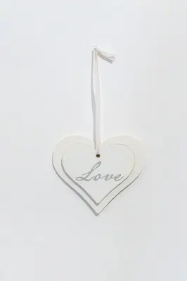 a white heart shaped ornament with the word love at Lion Renting Colosseum in Rome