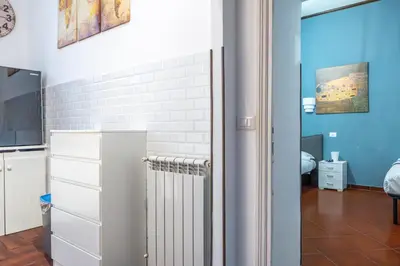 a room with a white brick wall and a radiator at Lion Renting Colosseum in Rome