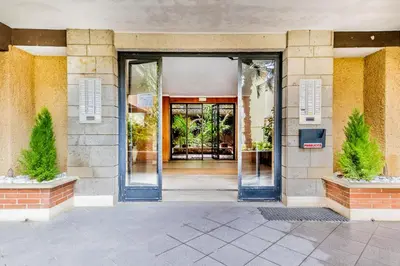 an entrance to a building with doors open at Domvs Domitilla in Rome
