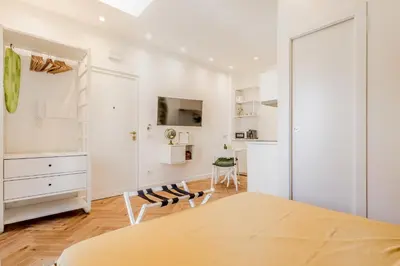 a white room with a table and chairs at Domvs Domitilla in Rome
