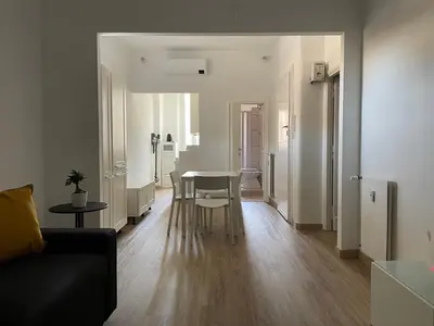 a living room with a table and a couch at AM Apartment San Giovanni in Rome