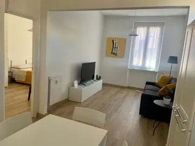 a living room with a couch and a television at AM Apartment San Giovanni in Rome