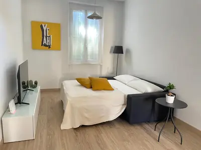 a bedroom with a bed and a table at AM Apartment San Giovanni in Rome