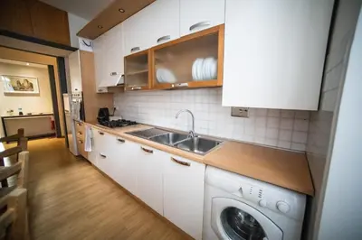 a kitchen with a sink and a washing machine at Rione Monti Home in Rome
