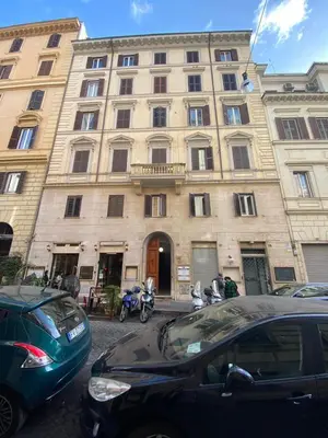 a large building with cars parked in front of it at Rione Monti Home in Rome