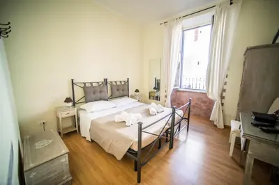 a bedroom with a bed and a large window at Rione Monti Home in Rome