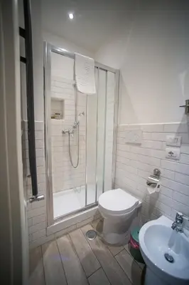 a bathroom with a shower and a toilet and a sink at Rione Monti Home in Rome