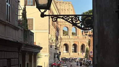 a view of a street with a building in the background at Colosseo Design Apartament in Rome