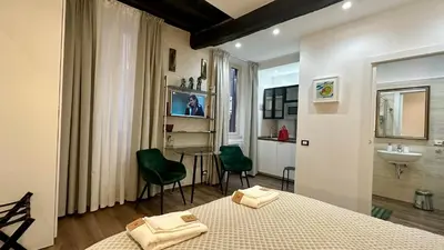 a bedroom with a bed and a bathroom with a sink at Colosseo Design Apartament in Rome