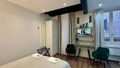 a bedroom with a bed and a table and chairs at Colosseo Design Apartament in Rome