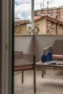 a balcony with a table and chairs and a window at Pigneto Apartment VaDo al Pigneto Collection in Rome