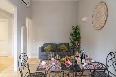a living room with a table and chairs with a couch at Pigneto Apartment VaDo al Pigneto Collection in Rome