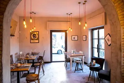 a restaurant with tables and chairs in a room at Pigneto Apartment VaDo al Pigneto Collection in Rome