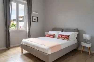 a bedroom with a bed with two pillows and a window at Pigneto Apartment VaDo al Pigneto Collection in Rome