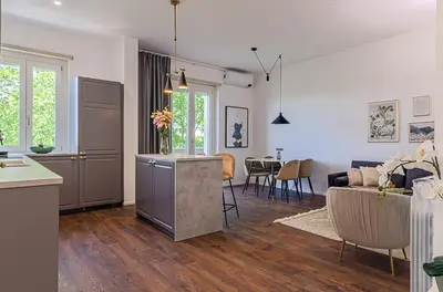 a kitchen and a living room with a couch and a table at Domus Campi Flegrei in Rome