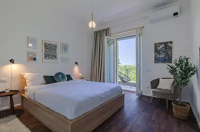a bedroom with a large bed and a balcony at Domus Campi Flegrei in Rome
