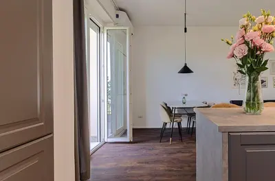 a kitchen with a vase of flowers on a counter at Domus Campi Flegrei in Rome