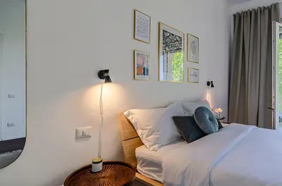 a bedroom with a bed and a table and a lamp at Domus Campi Flegrei in Rome