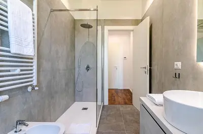 a bathroom with a glass shower and a sink at Domus Campi Flegrei in Rome
