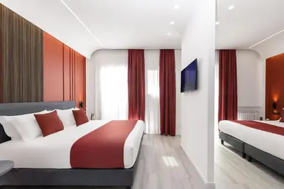 a hotel room with two beds and a television at St Peter Twelve in Rome
