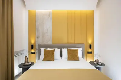 a bedroom with a large bed with yellow walls at St Peter Twelve in Rome