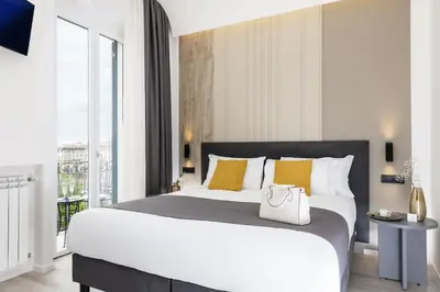 a bedroom with a large white bed with yellow pillows at St Peter Twelve in Rome