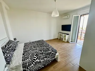 a bedroom with two beds with black and white sheets at Il Cielo Su Roma San Paolo in Rome